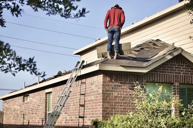 Professional roofer working on a residential roof in North Highlands